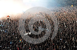 Crowd of people raising their hands at a concert